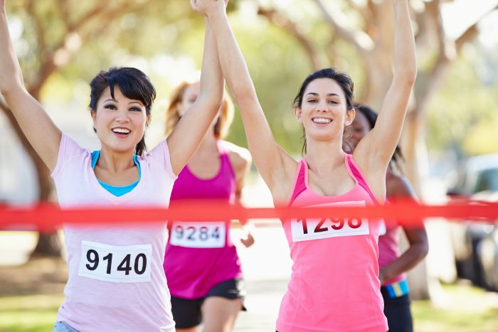 Two Female Runners Finishing Race Together