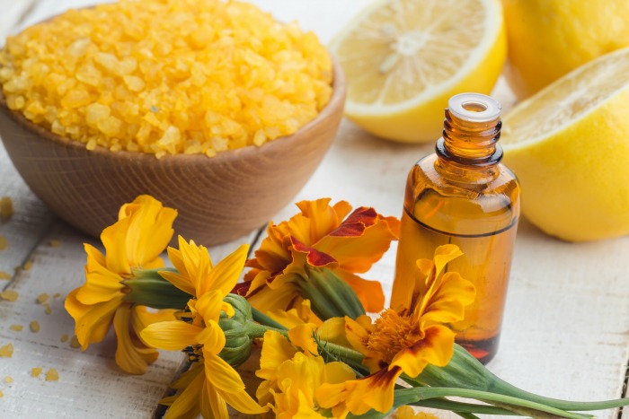 Essential aroma oil with lemon on wooden background. Selective focus.