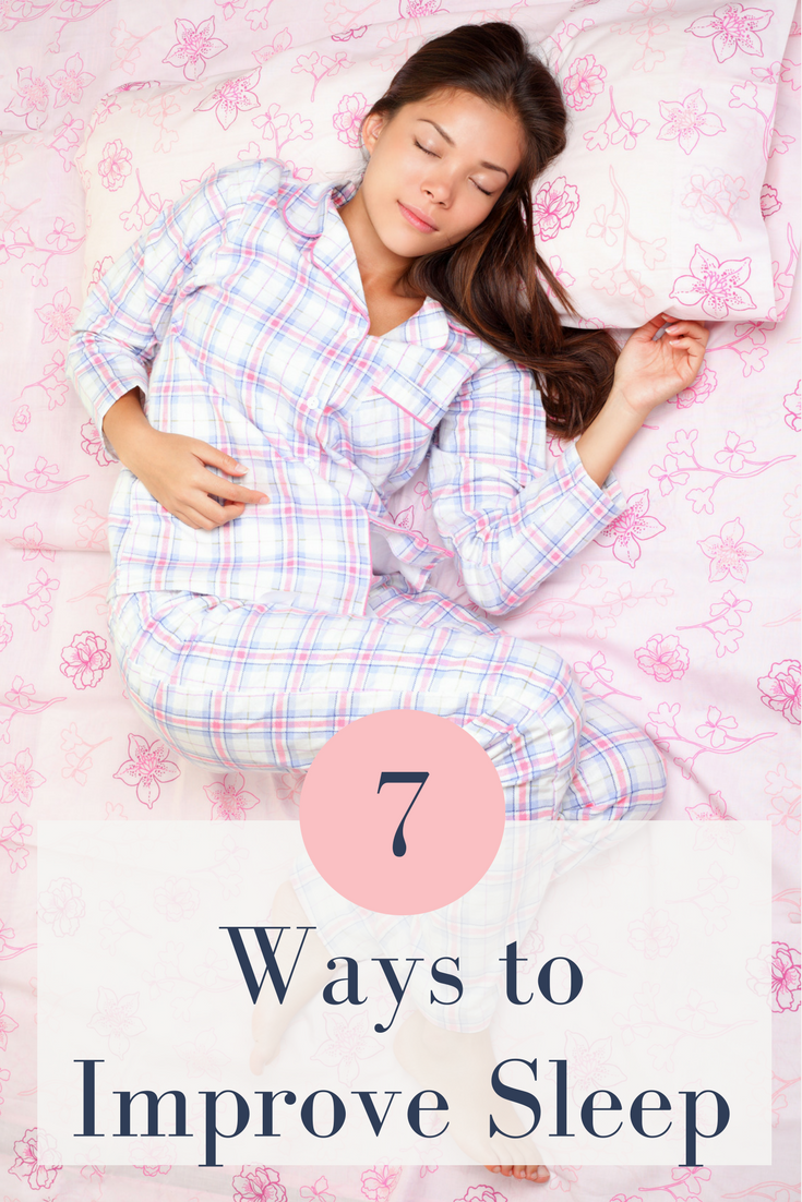 Picture of a brown haired woman sleeping in a pink room with plaid purple pajamas