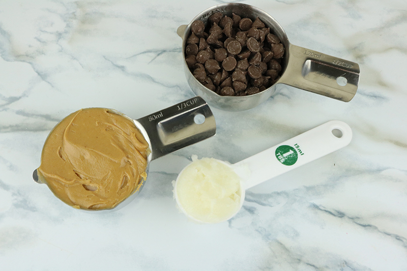 peanut butter, carob chips and coconut butter in measuring cups