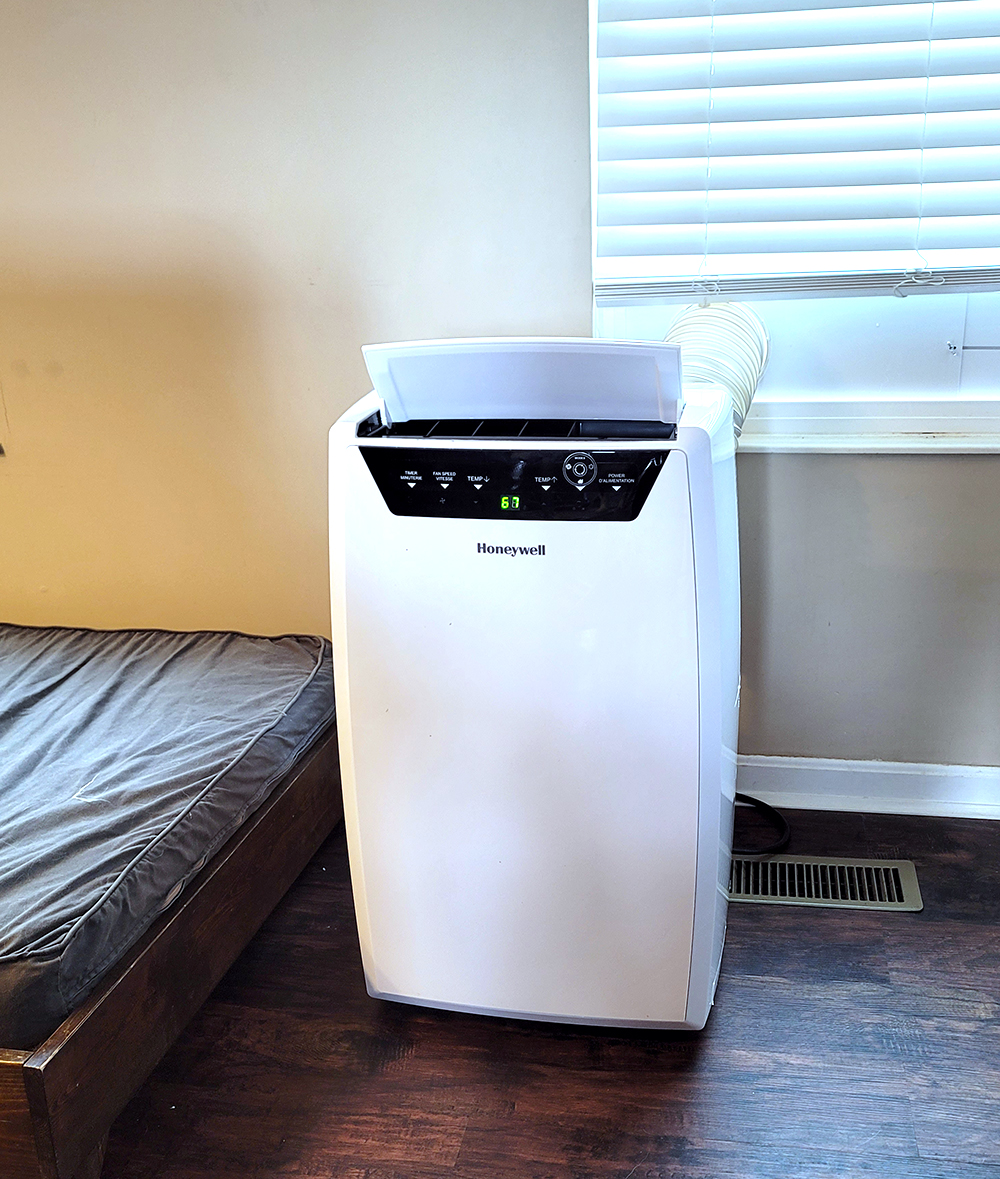 picture of a portable air conditioner near a pet bed and window