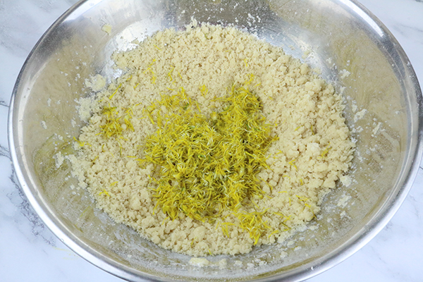 dandelion cookies batter being crumbly, putting in petals