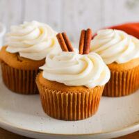 picture of 3 pumpkin cupcakes with cream cheese icing