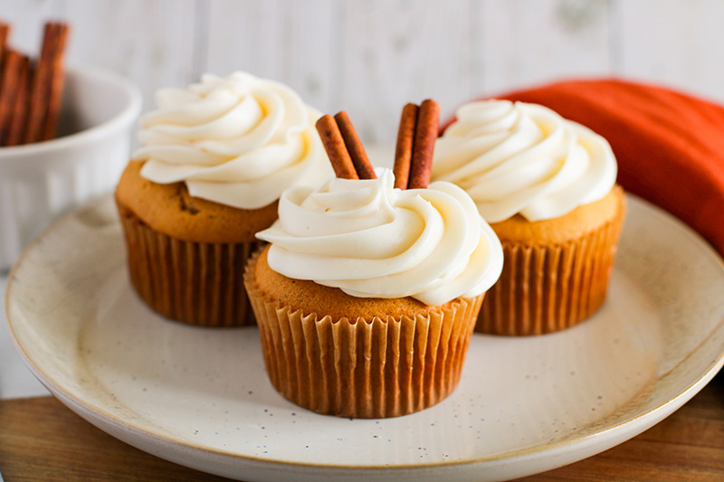 picture of 3 pumpkin cupcakes with cream cheese icing