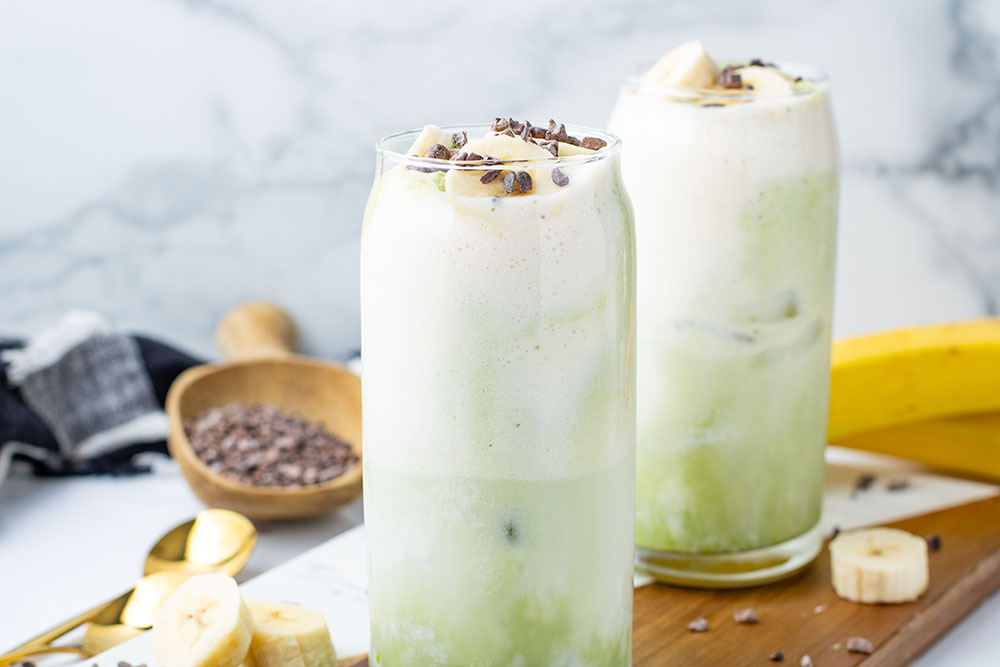 picture of a Banana Cream Matcha Latte ready to be served in a tall glass