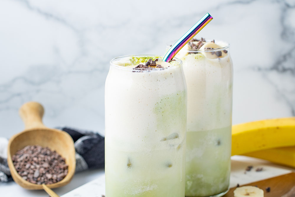 picture of a Banana Cream Matcha Latte ready to be served in a tall glass