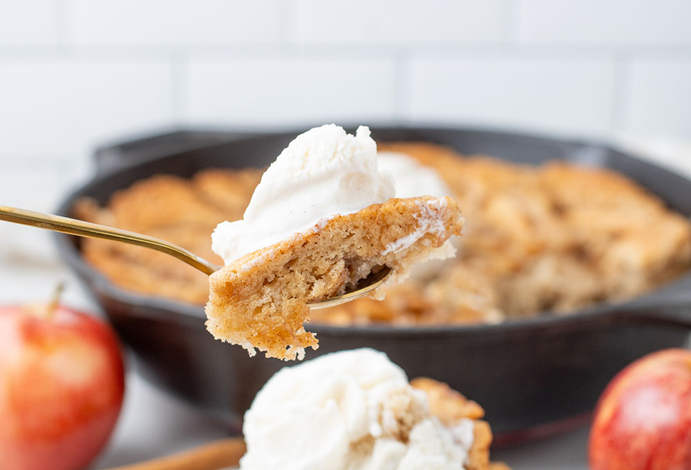 delicious apple pie cobbler recipe in a cast iron pan with the cobbler on a plate
