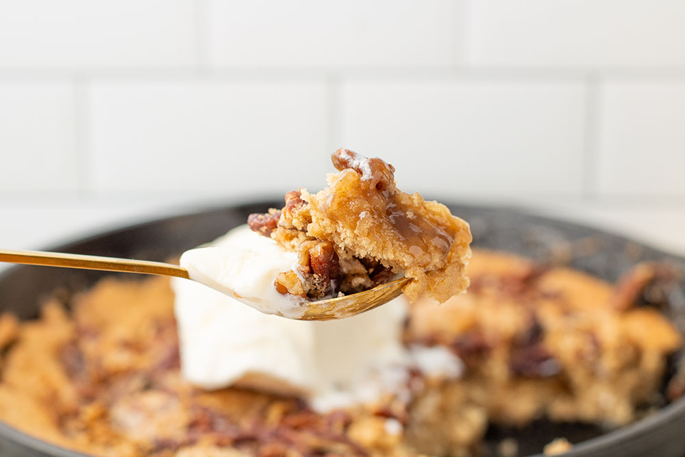 delicious homemade pecan pie cobbler in a cast iron pan