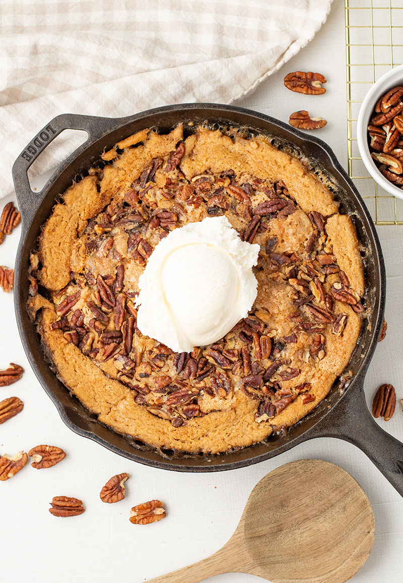 delicious homemade pecan pie cobbler in a cast iron pan
