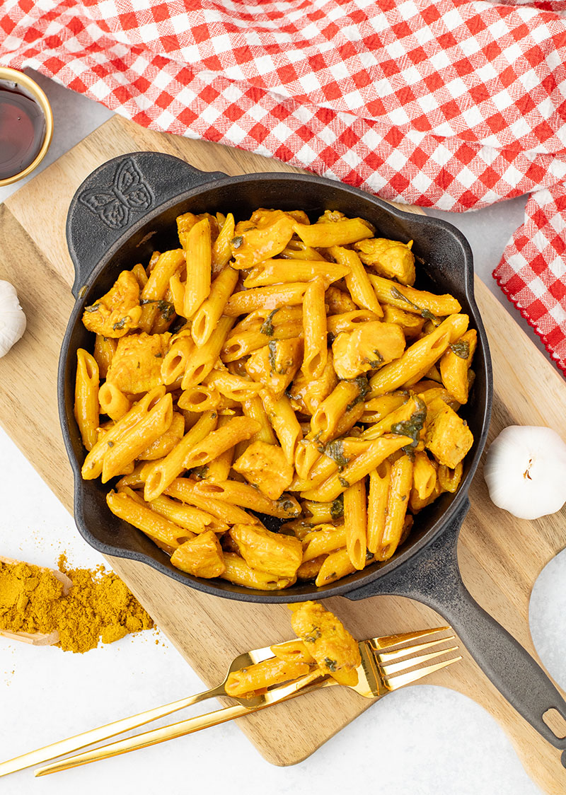 A bowl of maple chicken curry made in the Instant Pot but being served in a cast iron pan