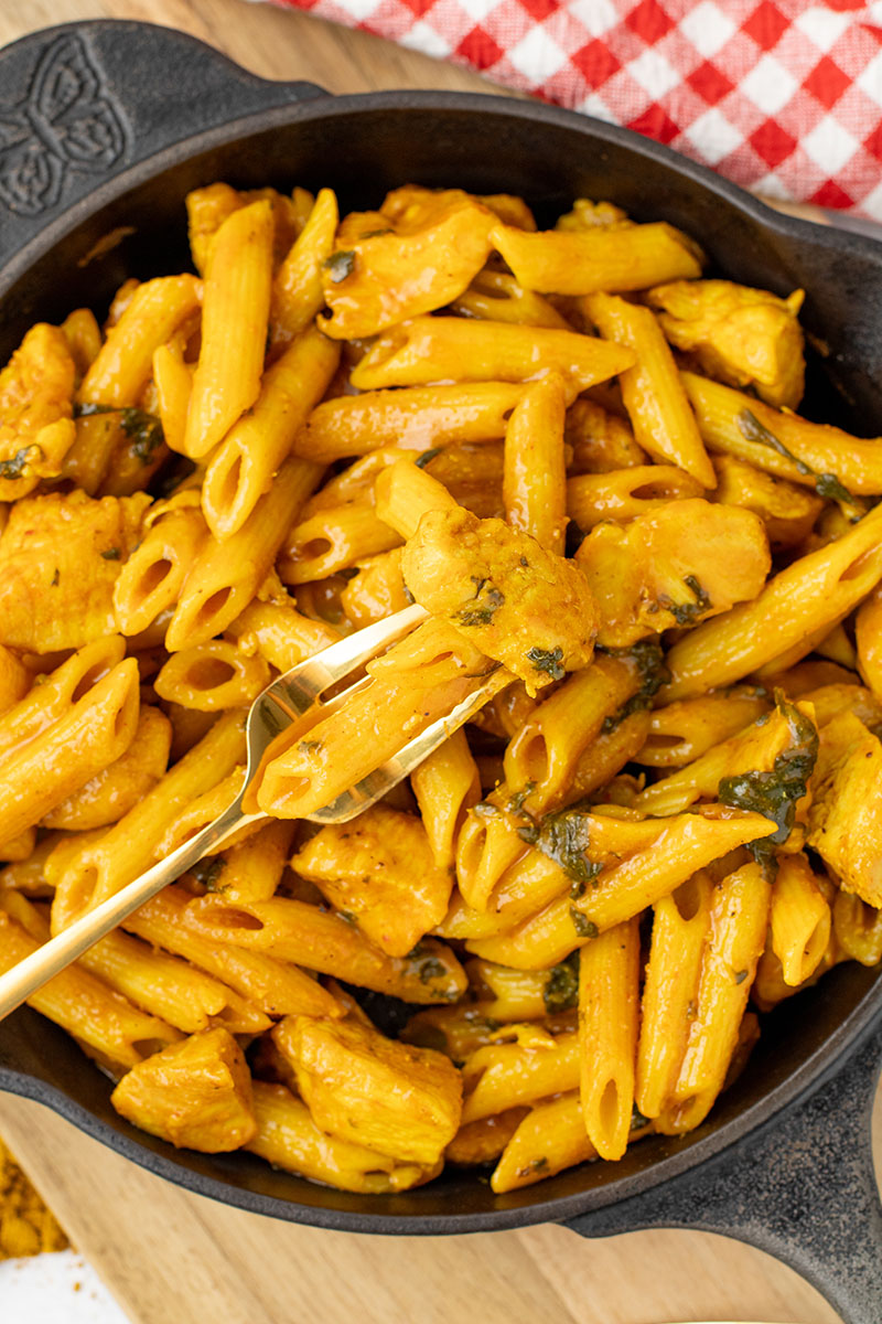 A bowl of maple chicken curry made in the Instant Pot but being served in a cast iron pan