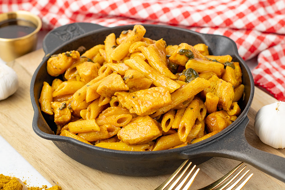 A bowl of maple chicken curry made in the Instant Pot but being served in a cast iron pan