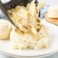 dish of Crockpot Chicken and Gravy on a plate with vegetables