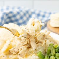dish of Crockpot Chicken and Gravy on a plate with vegetables